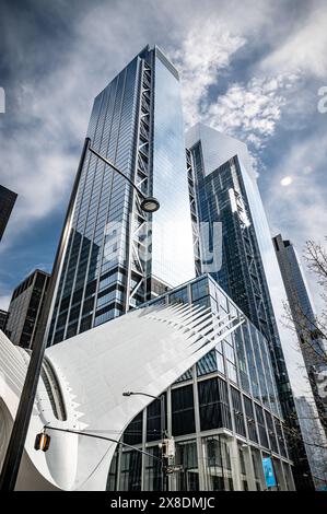 Oculus and Buildings in Manhattan seen from street level. Towering Manhattan buildings dwarf pedestrians on bustling streets. Stock Photo