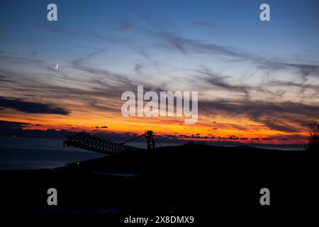Red-orange sky at sunset in twilight evening with dark clouds and moon. Nature sky. Background, horizon golden sky, sunrise cloud magnificent Stock Photo