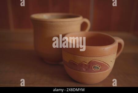 Empty earthenware mug on wooden table background. Stock Photo