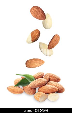 Many fresh almonds falling on white background Stock Photo