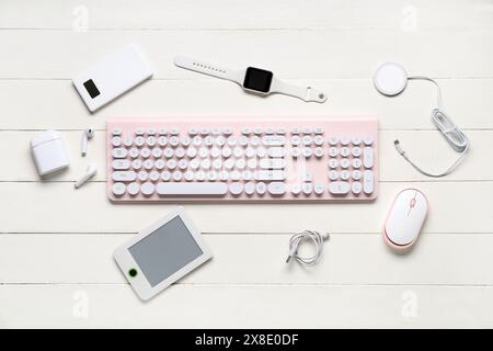 Composition with different modern gadgets on white wooden background Stock Photo