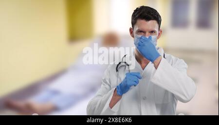 Image of caucasian male doctor over patient in hospital Stock Photo