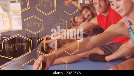 Image of multiple nft text banner over diverse fit people performing stretching exercise at gym Stock Photo