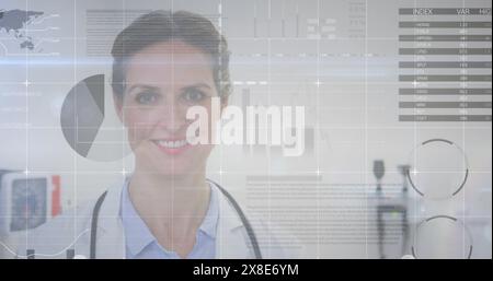 Image of statistical data processing over caucasian female doctor smiling at hospital Stock Photo
