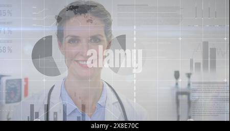 Image of statistical data processing over caucasian female doctor smiling at hospital Stock Photo
