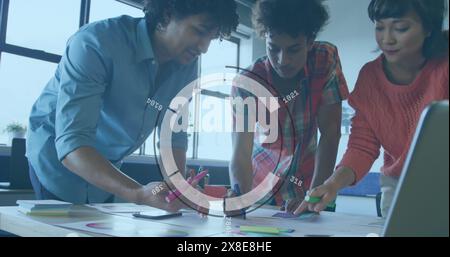 Image of round scanner against diverse colleagues discussing over documents at office Stock Photo
