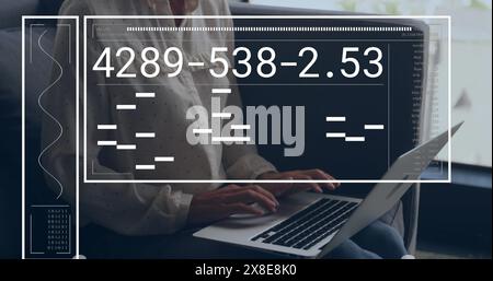 Image of interface with data processing on mid section of a businesswoman using laptop at office Stock Photo