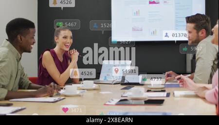 Image of changing numbers and icons in notification bars, diverse coworkers discussing reports Stock Photo