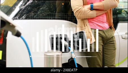 Image of statistical data processing over mid section of man waiting while his car is charging Stock Photo