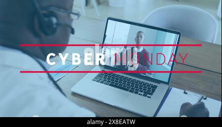 Image of cyber monday text over african american senior male doctor having a imagecall on laptop Stock Photo