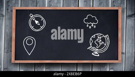 In school, a compass, rain cloud, and globe are drawn on the blackboard Stock Photo