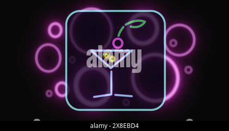 Neon sign showing martini glass with olive and cherry, glowing in purple hues Stock Photo