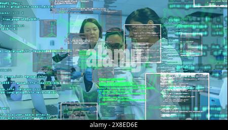 Caucasian female scientist and diverse male peer review data on screens Stock Photo