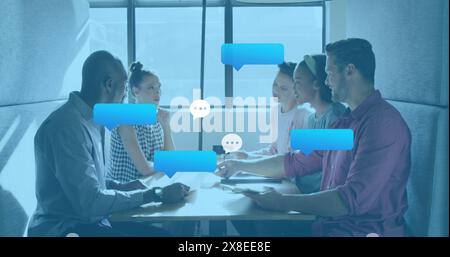 Diverse group of colleagues discussing project at table Stock Photo