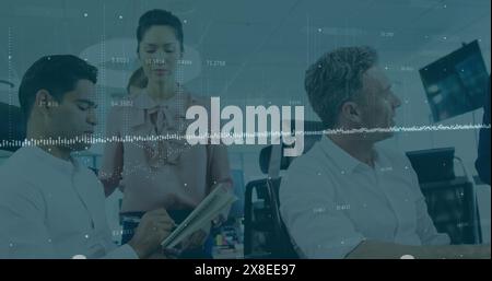 Image of data processing over diverse male and female colleagues discussing at office Stock Photo
