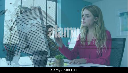Image of rotating globe and computer language over caucasian woman analyzing reports Stock Photo