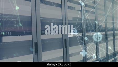 Image of spinning globes of medical icons and light trails against computer server room Stock Photo