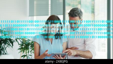 Image of binary codes over caucasian coworkers discussing reports on digital tablet Stock Photo