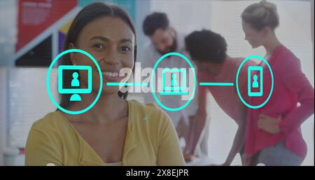 Image of flowchart of icons over smiling biracial woman standing arms crossed in office Stock Photo