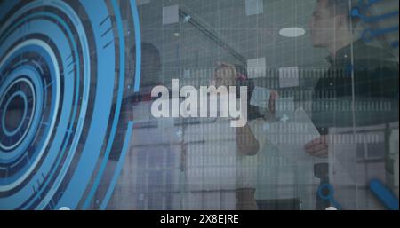 Image of loading circles and computer language, diverse coworkers discussing strategy Stock Photo