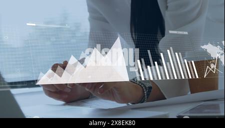 Image of statistical data processing against mid section of a businessman working on a plan Stock Photo
