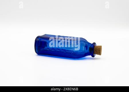 Blue glass bottle with a cork cap on white background Stock Photo