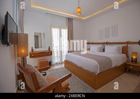 Interior design decor furnishing of luxury show home bedroom showing furniture and double bed with balcony terrace Stock Photo