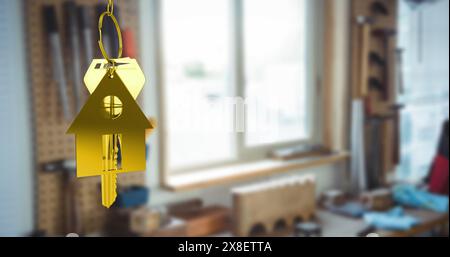 Image of hanging golden house keys against interior of a living room Stock Photo