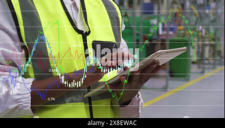 Image of graphs and numbers over midsection of diverse female employees using digital tablets Stock Photo