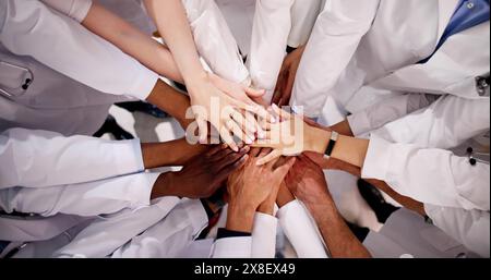Medical Team Stacking Hands Against In Hospital Stock Photo