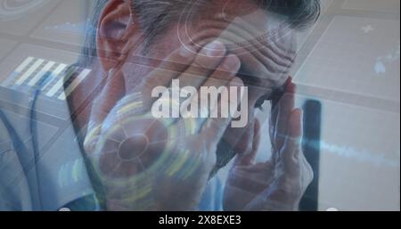 Image of interface with data processing against close up of a caucasian senior man at office Stock Photo