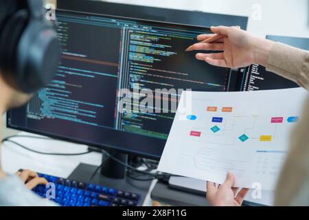 close up developer discussion about app flowchart coding at desk in modern office Stock Photo