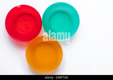 Colorful plastic tableware isolated on white background with copy space. Top view. Stock Photo