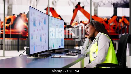 Tired Unhappy Woman In Automotive Car Factory Using Scada System Stock Photo
