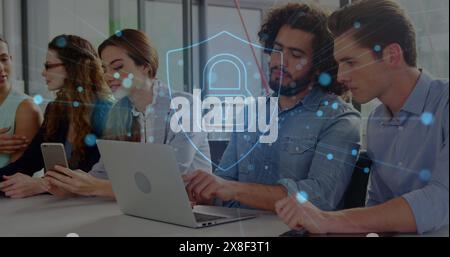 Group of Caucasian young professionals working on laptops and smartphones Stock Photo