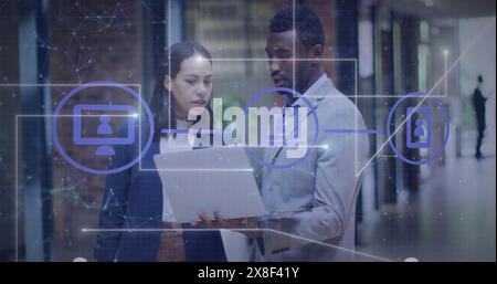 Image of lines, connected icons over connected dots, diverse coworkers discussing reports Stock Photo