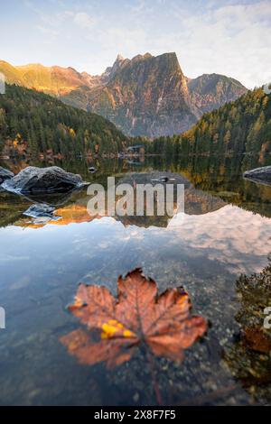 Mountain peaks of the Oetztal Alps reflected in Lake Piburger See, in ...