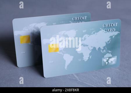Two credit cards on grey textured table, closeup Stock Photo