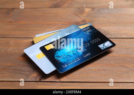 Many plastic credit cards on wooden table Stock Photo