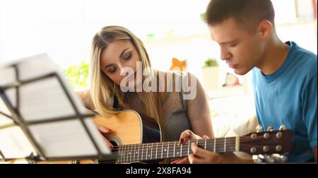 Music Playing Lesson Lovers Couple at Living Room Stock Photo