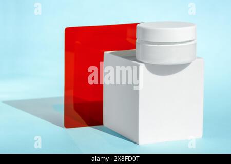 White cosmetic jar with red and blue elements Stock Photo