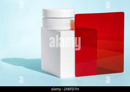 White cosmetic jar with red and blue elements Stock Photo