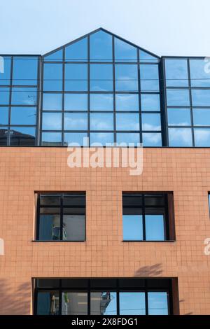 Modern brick and glass facade of the office building. A contrasting ...
