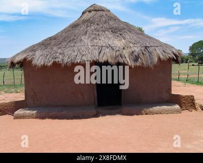 traditional african hut, rondavel with thatched roof and mud clay walls Stock Photo