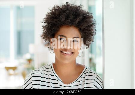 Portrait, businesswoman and smile in office with pride for work, small business and receptionist in creative agency. Personal assistant, startup and Stock Photo