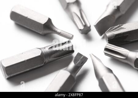 Different screwdriver bits on white background, closeup Stock Photo