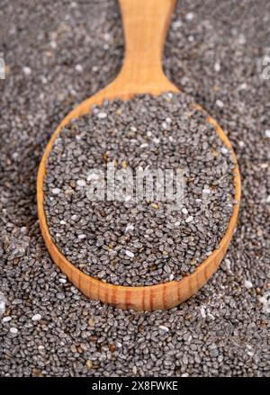 Scattered chia seeds with wooden spoon close up Stock Photo