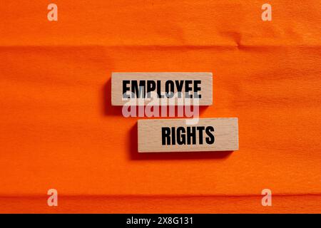 Employee rights words written on wooden blocks with orange background. Conceptual employee rights symbol. Copy space. Stock Photo