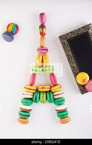 A creative art project featuring an Eiffel Tower made from macaroni displayed next to a purple box, combining art with fashion design and crafts. Stock Photo