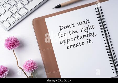 Notepad and inspirational quote don't wait for right opportunity, create it Stock Photo